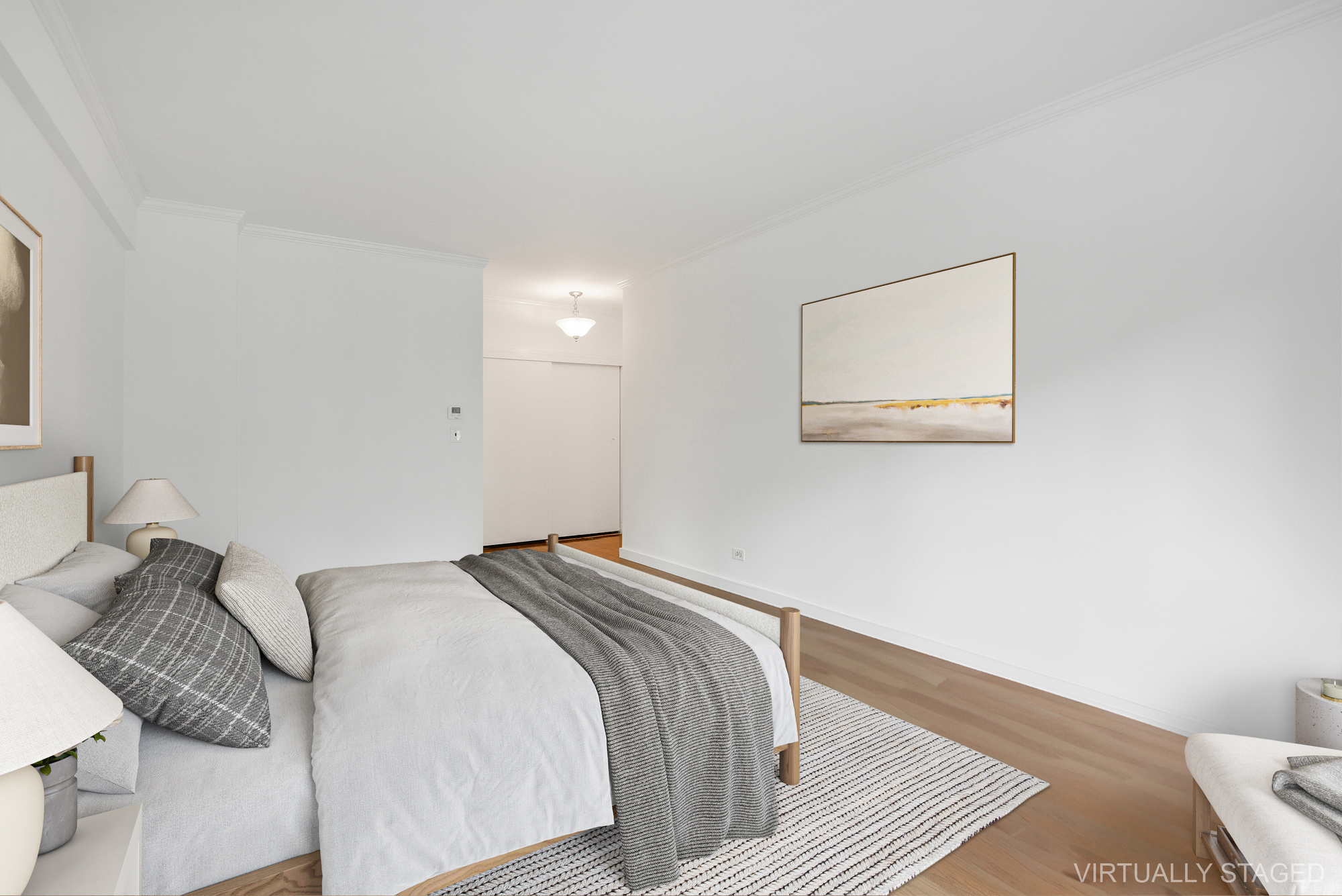 16 Sutton Place, Unit 2B Manhattan, NY 10022 - Photo 7 of 20 a bedroom with a bed and a painting on the wall