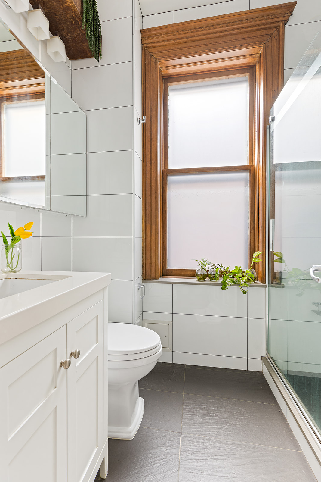 205 Park Place, Unit 13 Brooklyn, NY 11238 - Photo 5 of 8 a bathroom with a toilet a sink and a window