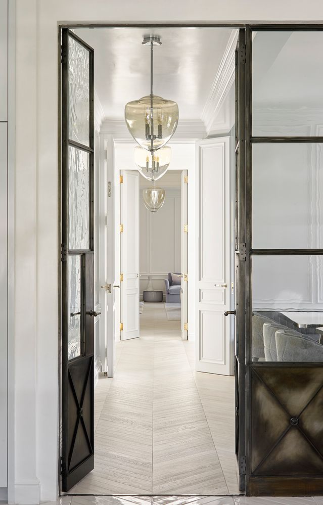 a view of a hallway with a chandelier and living room