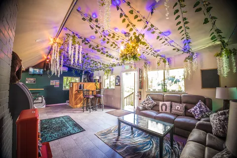 a view of a chairs and tables in patio with a barbeque