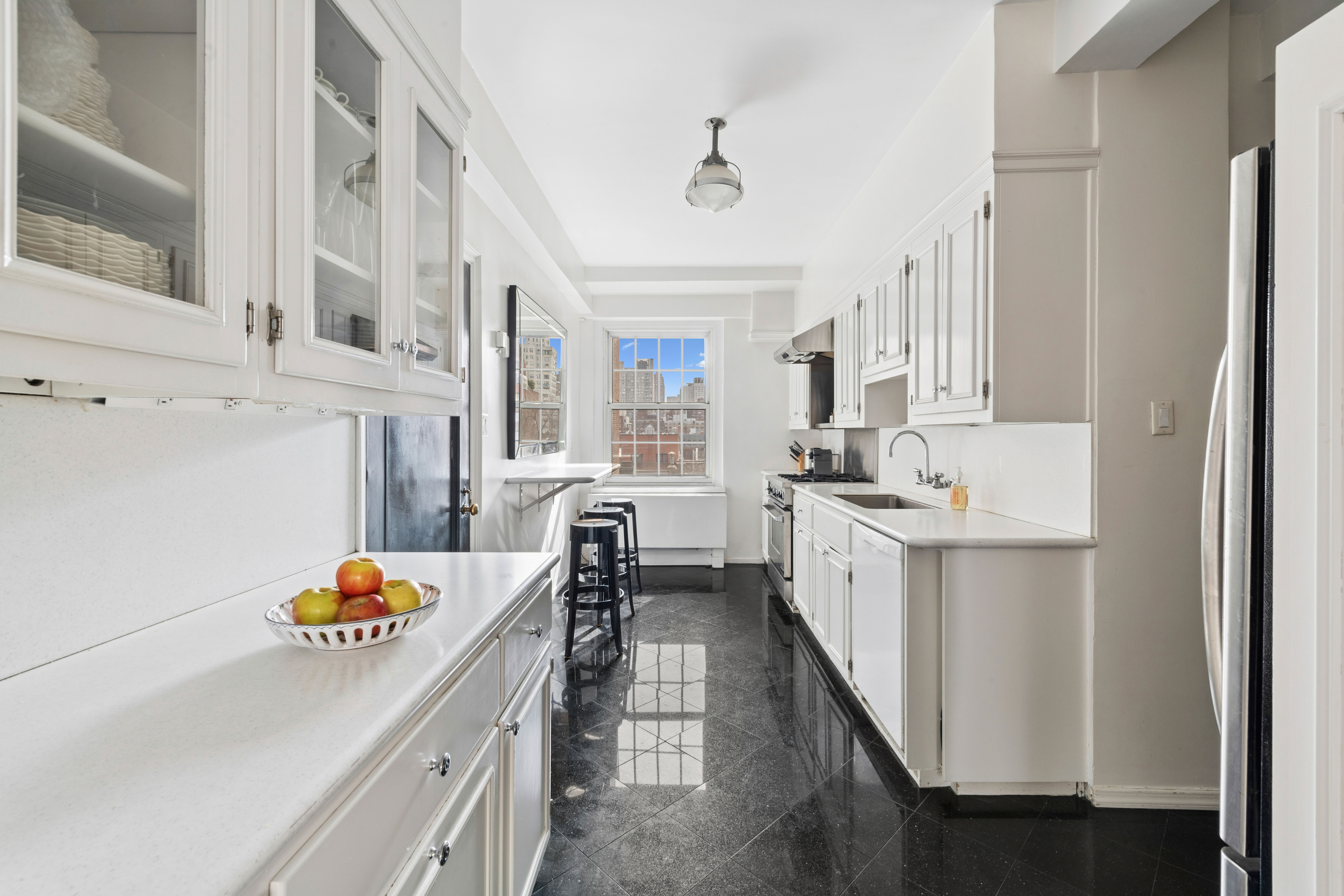 520 East 86th Street, Unit 9B Manhattan, NY 10028 - Photo 7 of 18 a kitchen with stainless steel appliances granite countertop a sink and cabinets