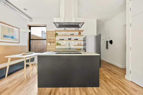 a view of a kitchen with granite countertop a sink and a stove