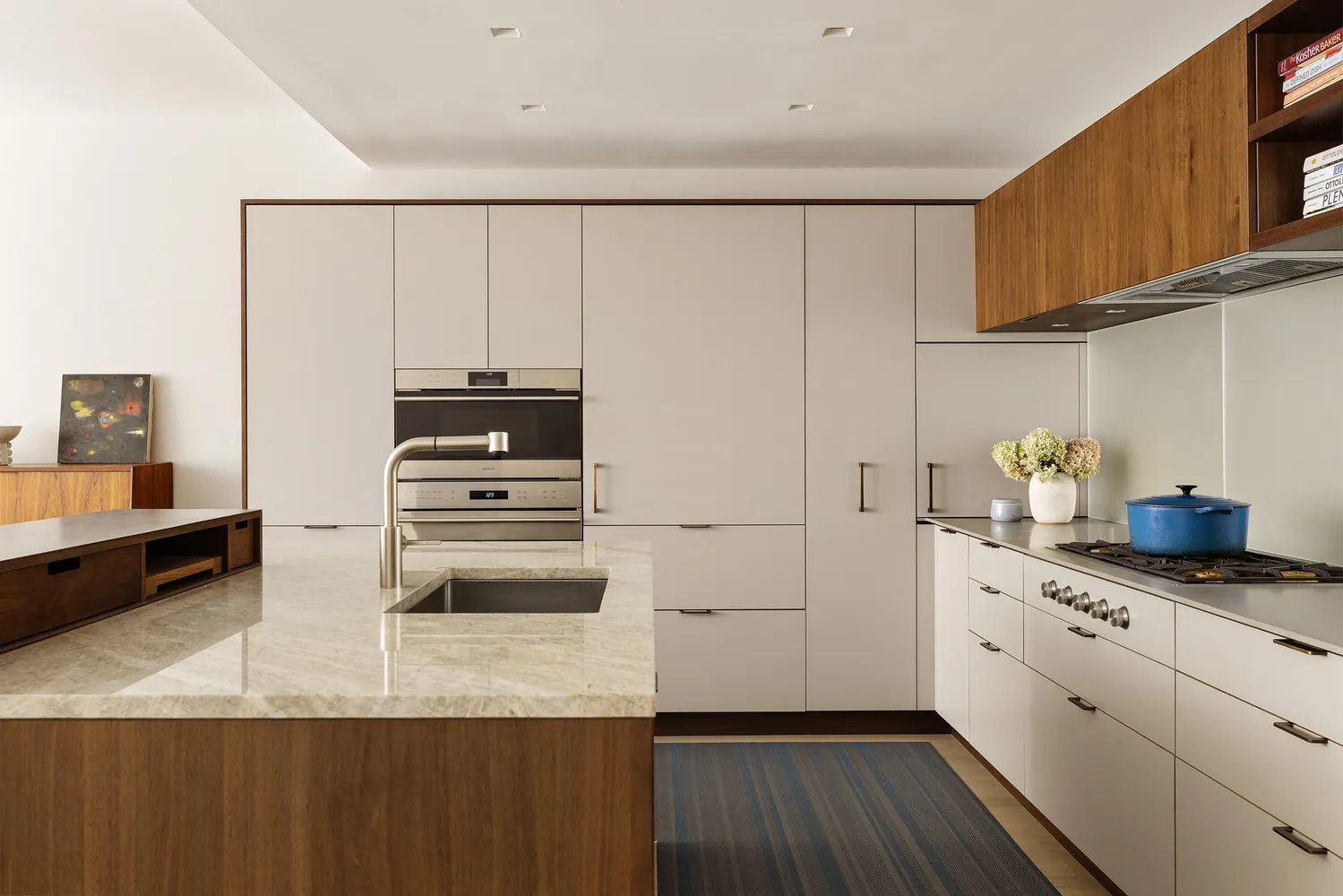 a kitchen with stainless steel appliances a microwave a stove and white cabinets