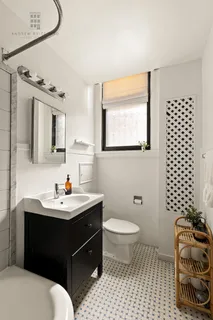 a bathroom with a sink toilet a mirror and shower