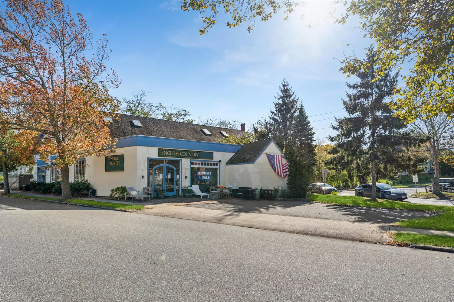 a view of a house with a yard and large trees