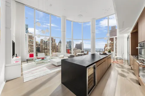 a kitchen with kitchen island a sink and a large window