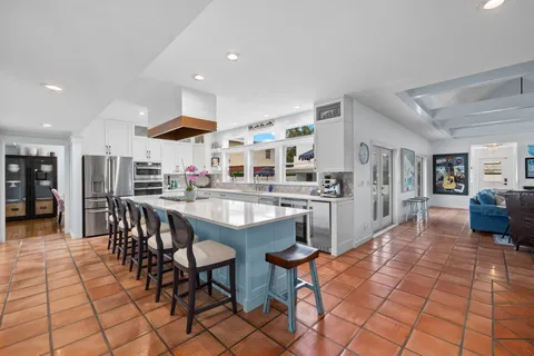 a kitchen with stainless steel appliances kitchen island granite countertop a sink and cabinets