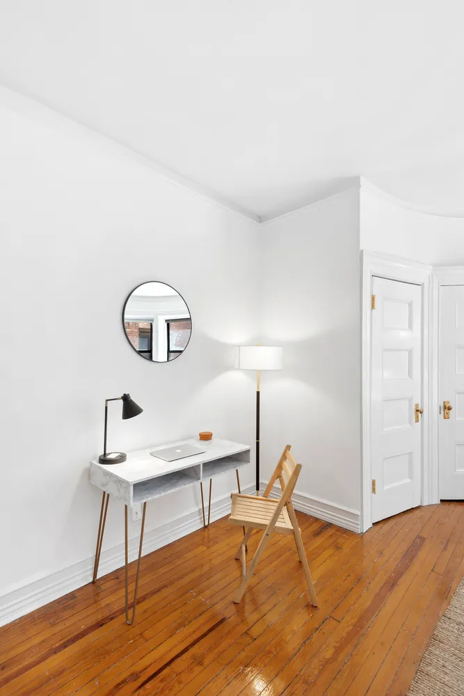 a bedroom with a bed and a table