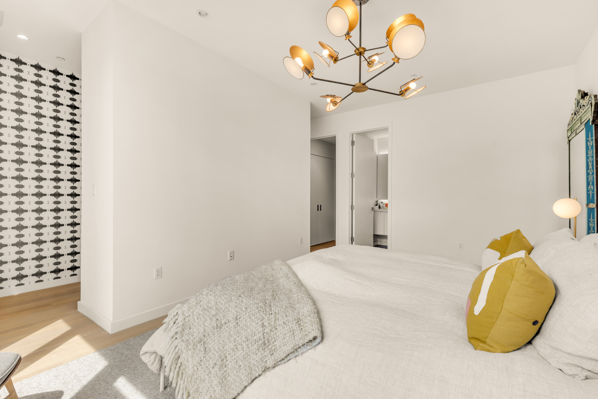 1501 4th Street Northwest, Unit 1 Washington, DC 20001 - Photo 30 of 41 a bedroom with a bed and a chandelier