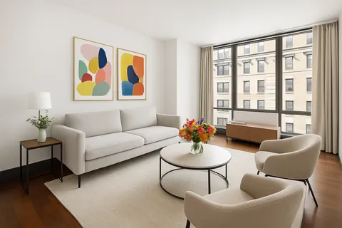 a living room with furniture and a large window with wooden floor