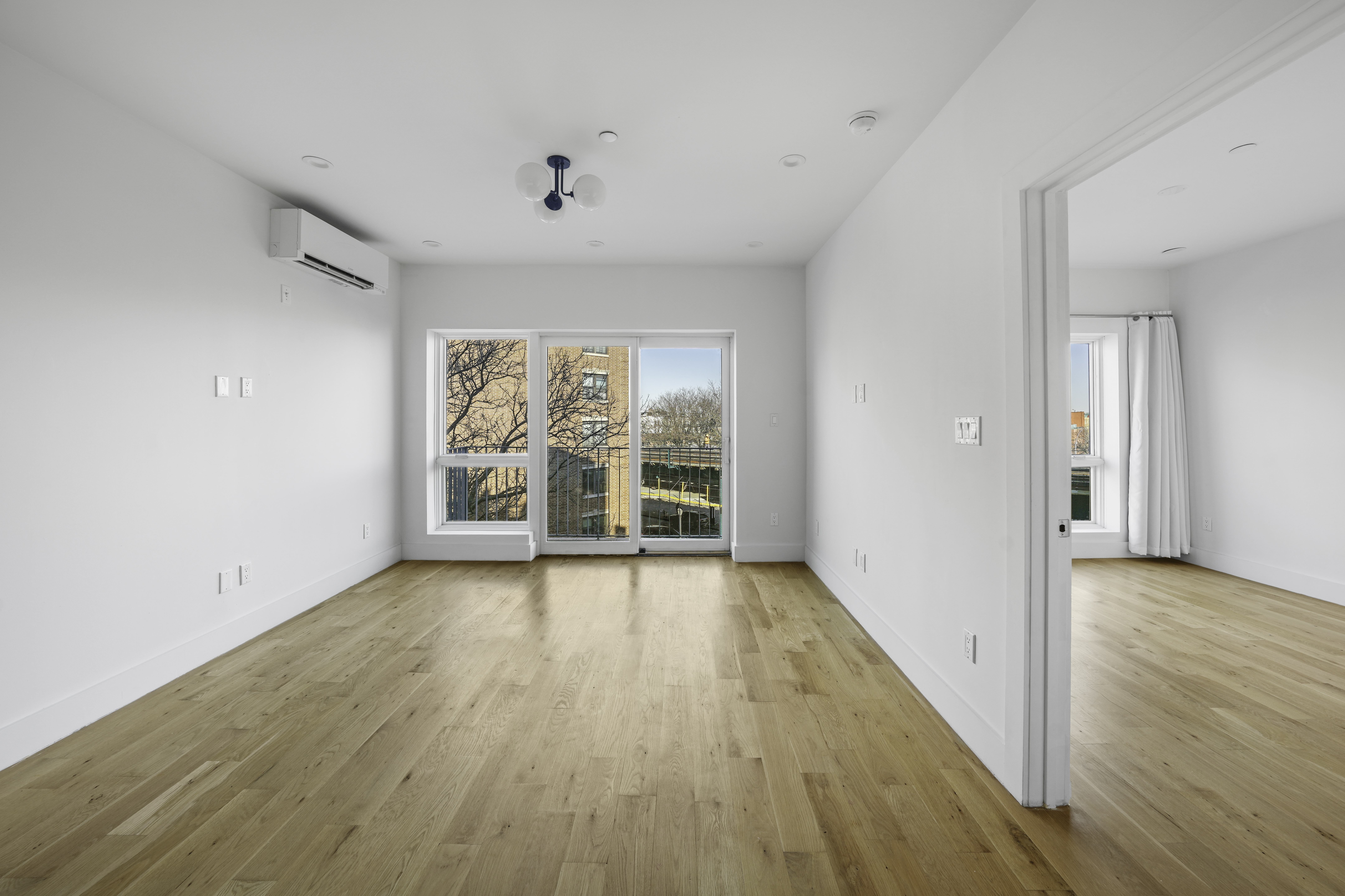 766 Decatur Street, Unit 4A Brooklyn, NY 11233 - Photo 2 of 12 wooden floor in an empty room with a window