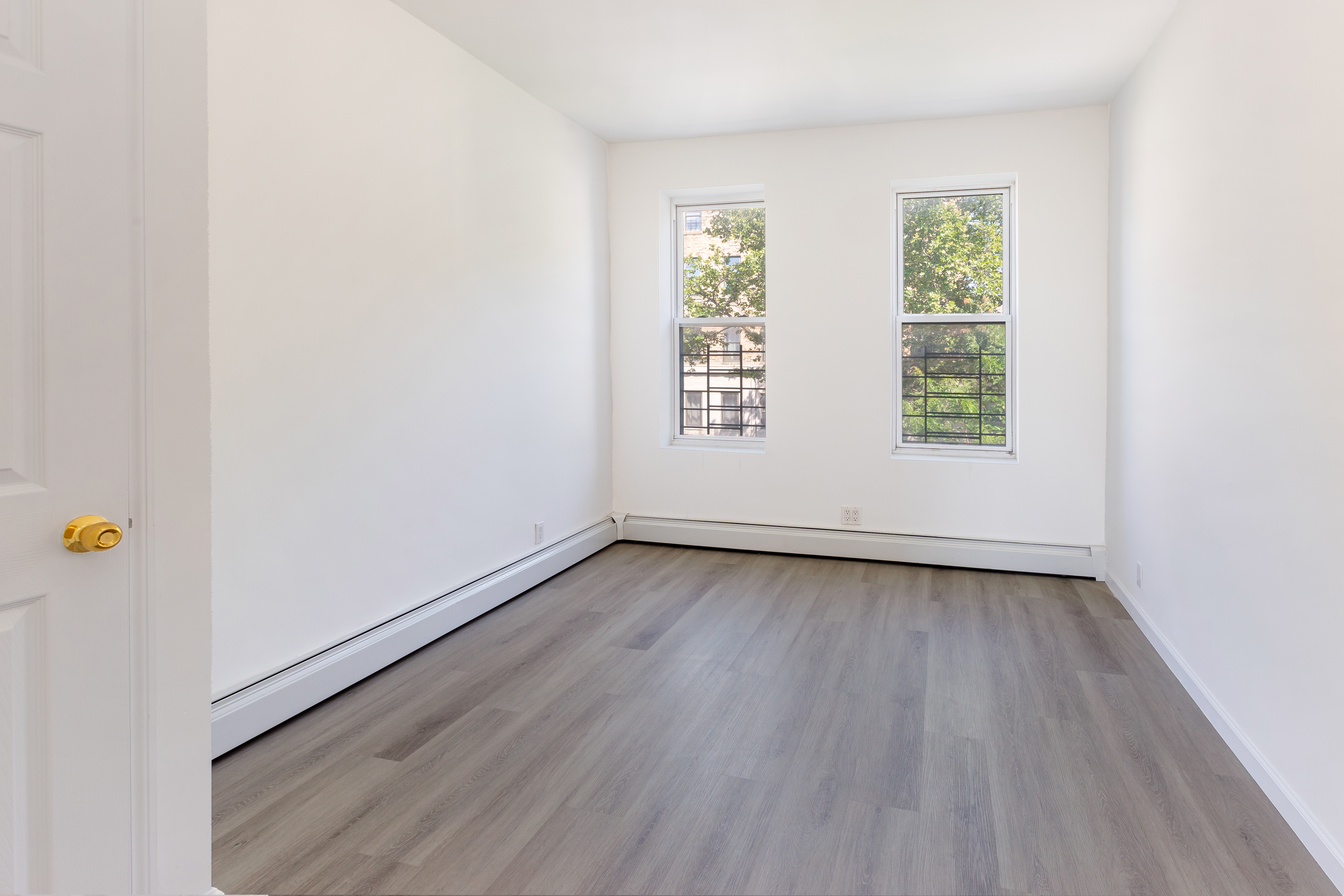1030 Winthrop Street, Unit 2A Brooklyn, NY 11212 - Photo 6 of 10 an empty room with wooden floor and window