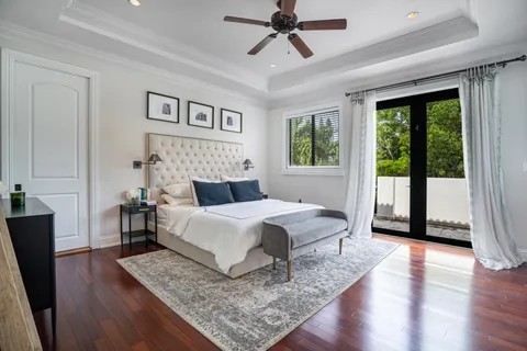 a spacious bedroom with a large bed and a chandelier