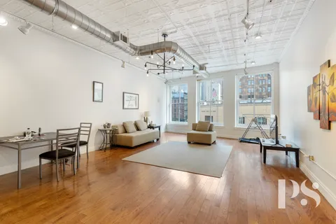 a living room with furniture or wooden floor and a chandelier