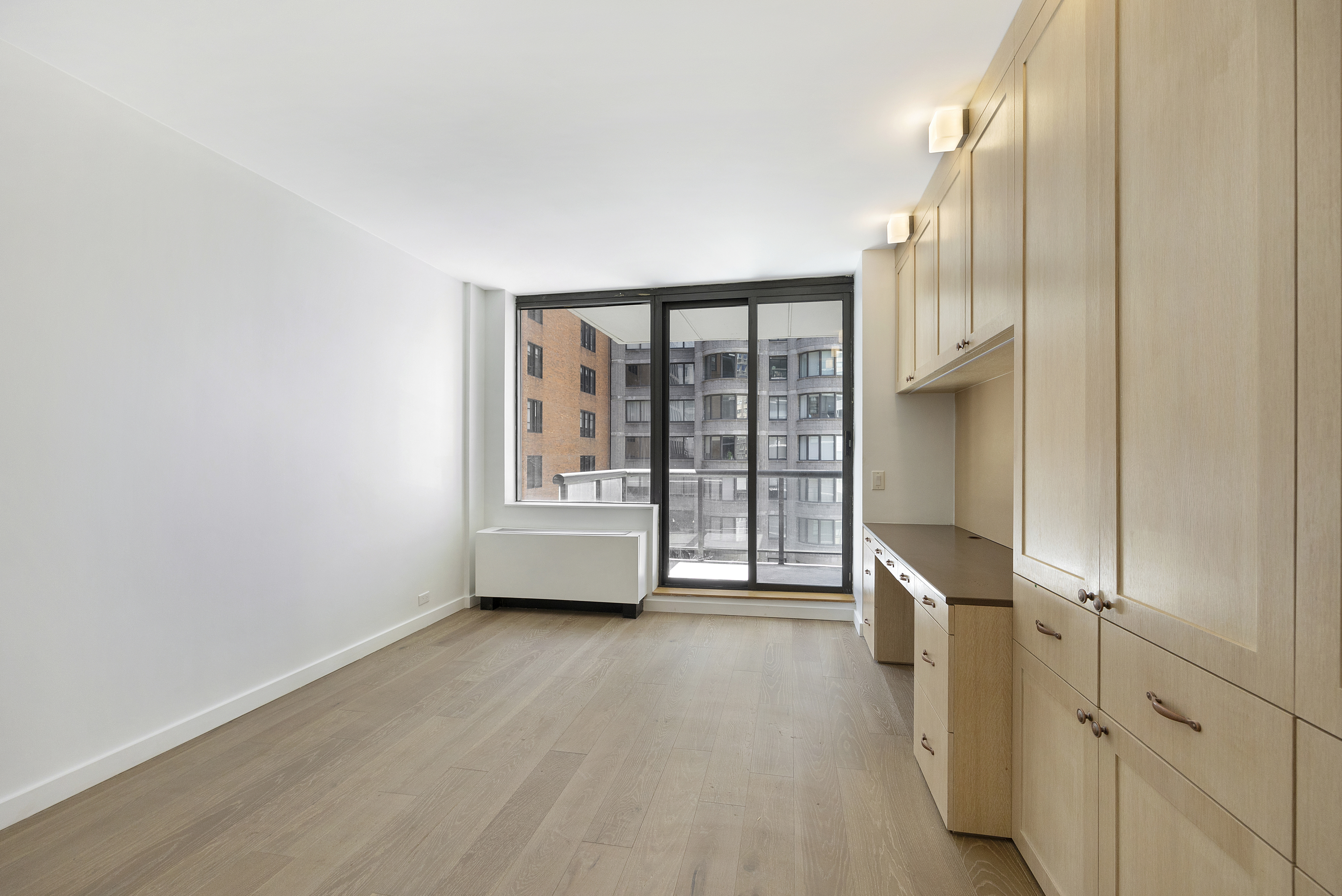 62 West 62nd Street, Unit 18A Manhattan, NY 10023 - Photo 7 of 16 a view of an empty room with a window
