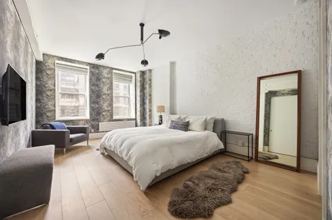 a spacious bedroom with a bed and a couch