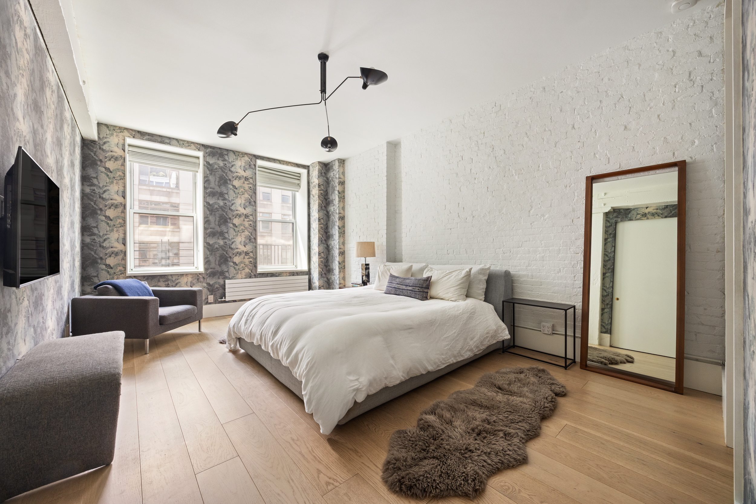 622 Greenwich Street, Unit 4B Manhattan, NY 10014 - Photo 20 of 27 a spacious bedroom with a bed and a couch