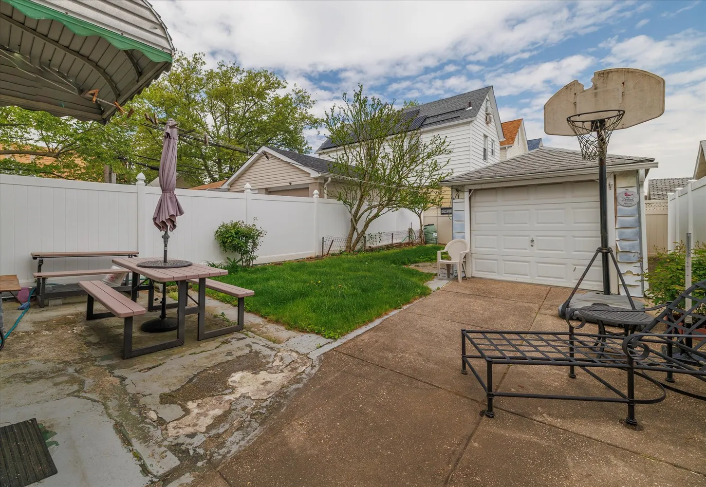 a view of a patio with a table chairs and a fire pit