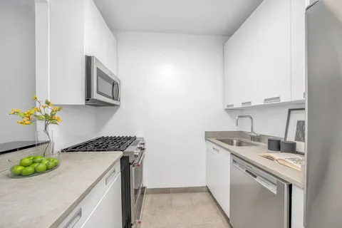 a kitchen with stainless steel appliances granite countertop a sink and a stove