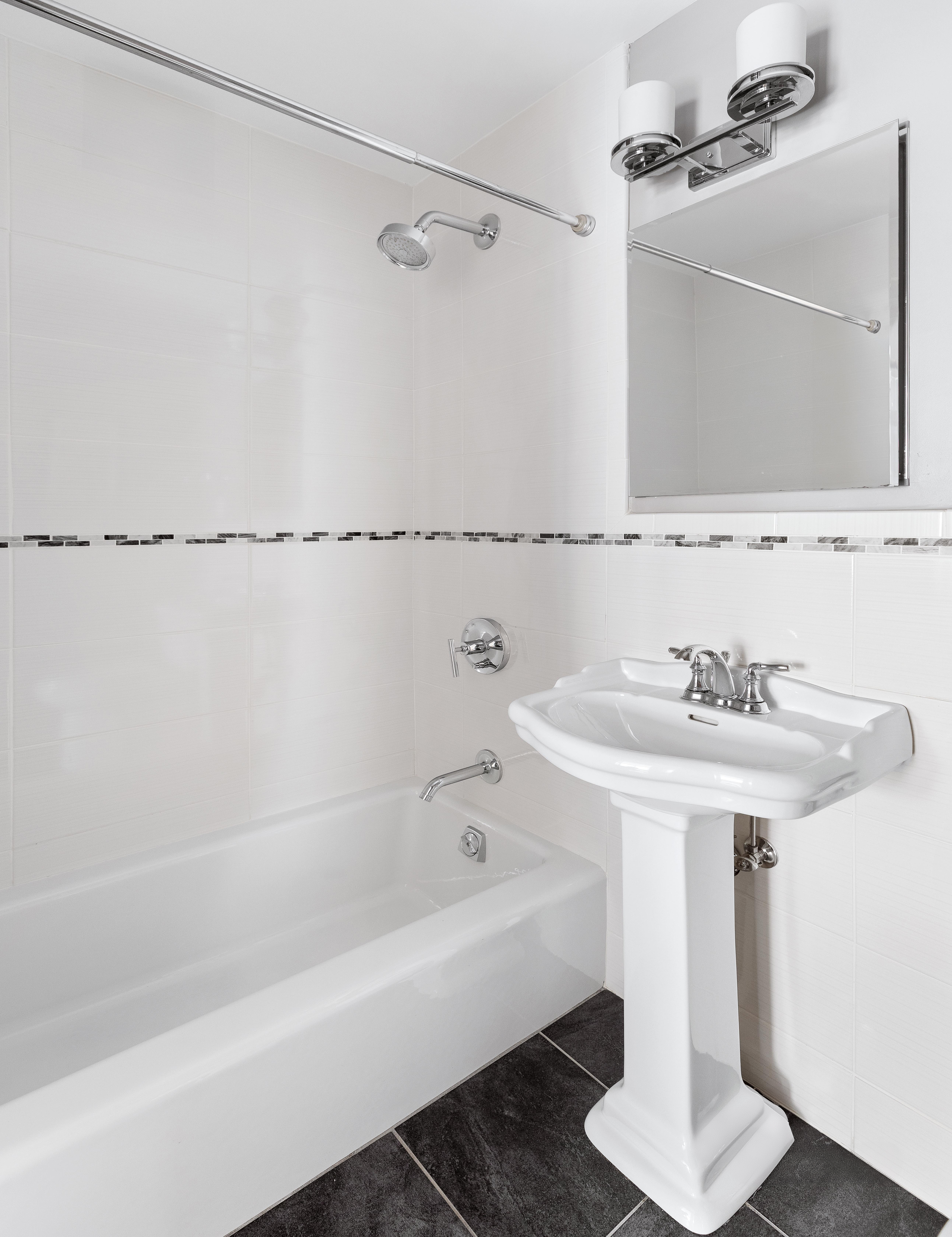 15 West 72nd Street, Unit 8TU Manhattan, NY 10023 - Photo 10 of 12 a bathroom with a sink and a mirror