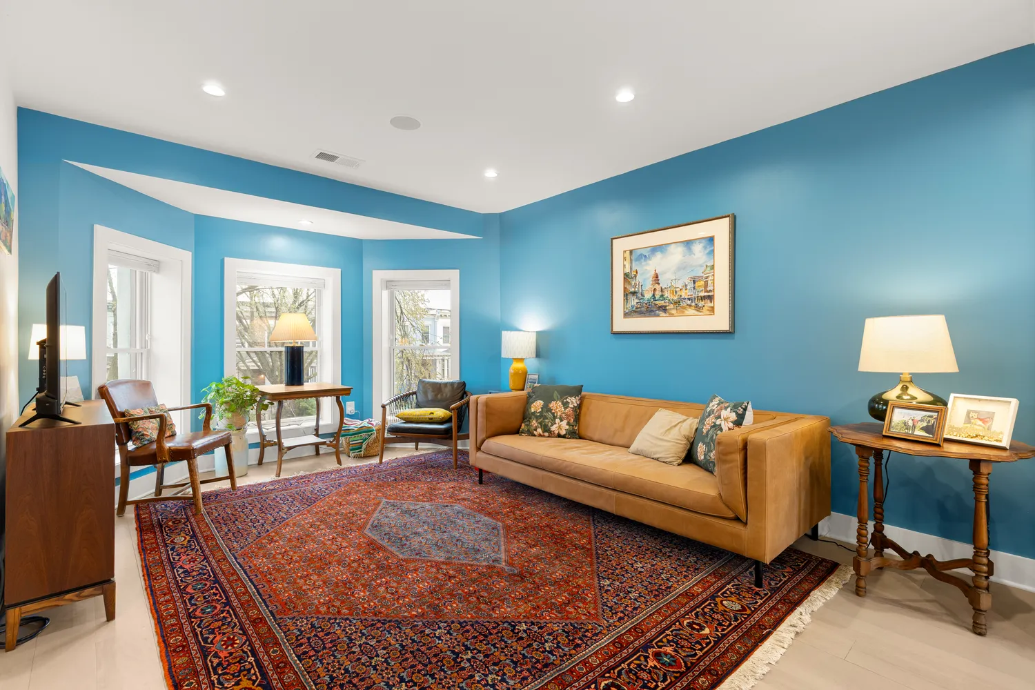 a living room with furniture a rug and a large window