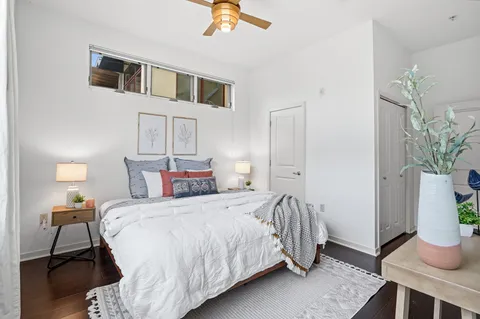 a bedroom with a bed and a potted plant