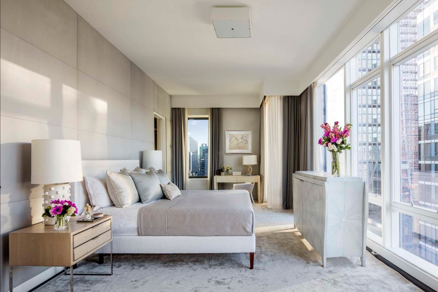 20 West 53rd Street, Unit 42A Manhattan, NY 10019 - Photo 12 of 31 a living room with furniture and flowers