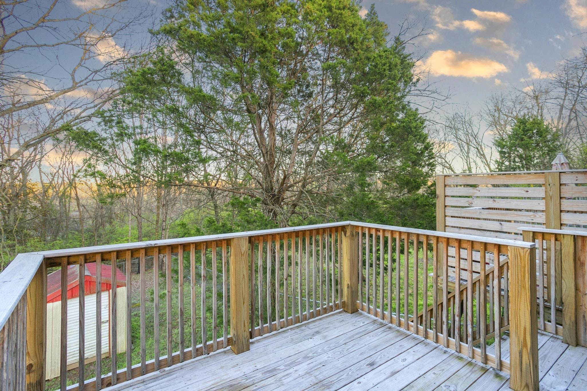 Falls Creek Drive, Unit 3307 & 3309 Nashville, TN 37214 - Photo 3 of 51 a balcony with wooden floor and trees in the back