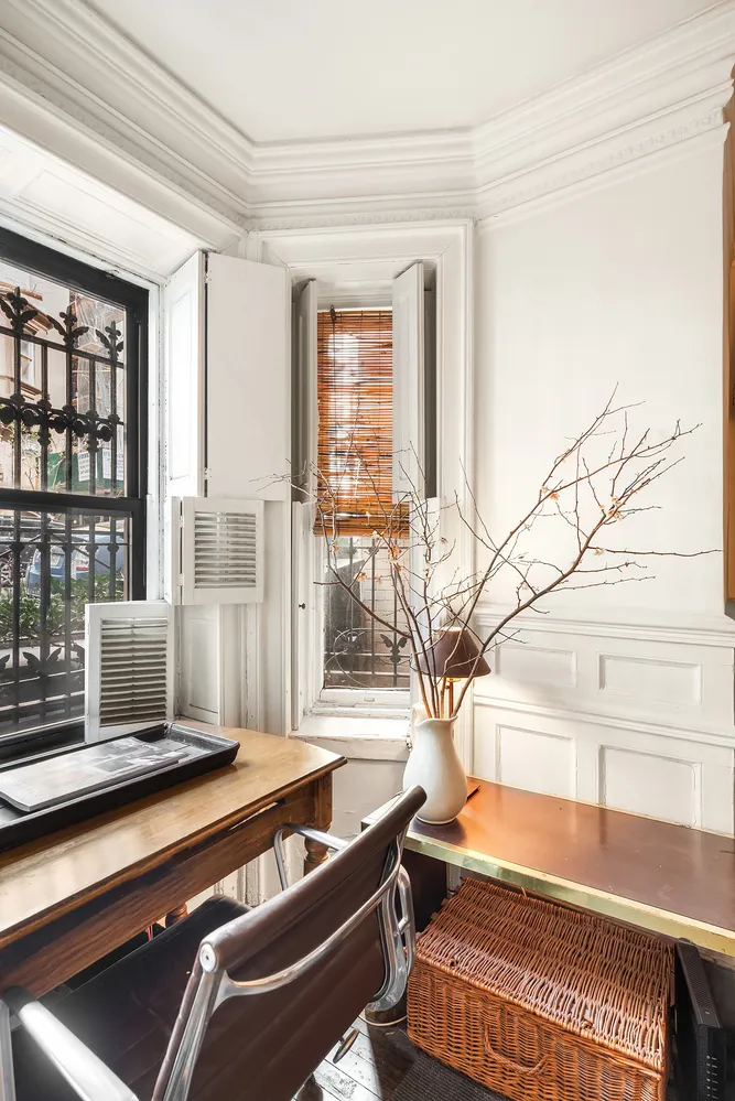 a living room with a fireplace and a wooden floor