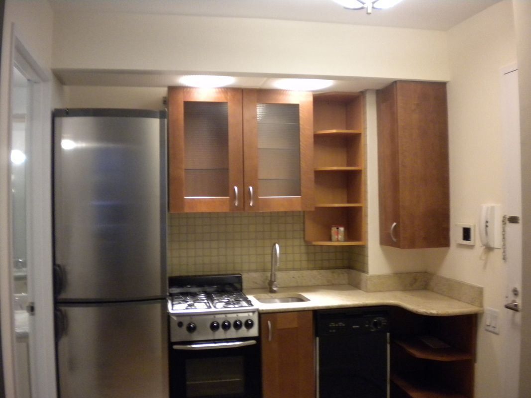 45 East 25th Street, Unit 12E Manhattan, NY 10010 - Photo 2 of 5 a kitchen with a sink and a refrigerator