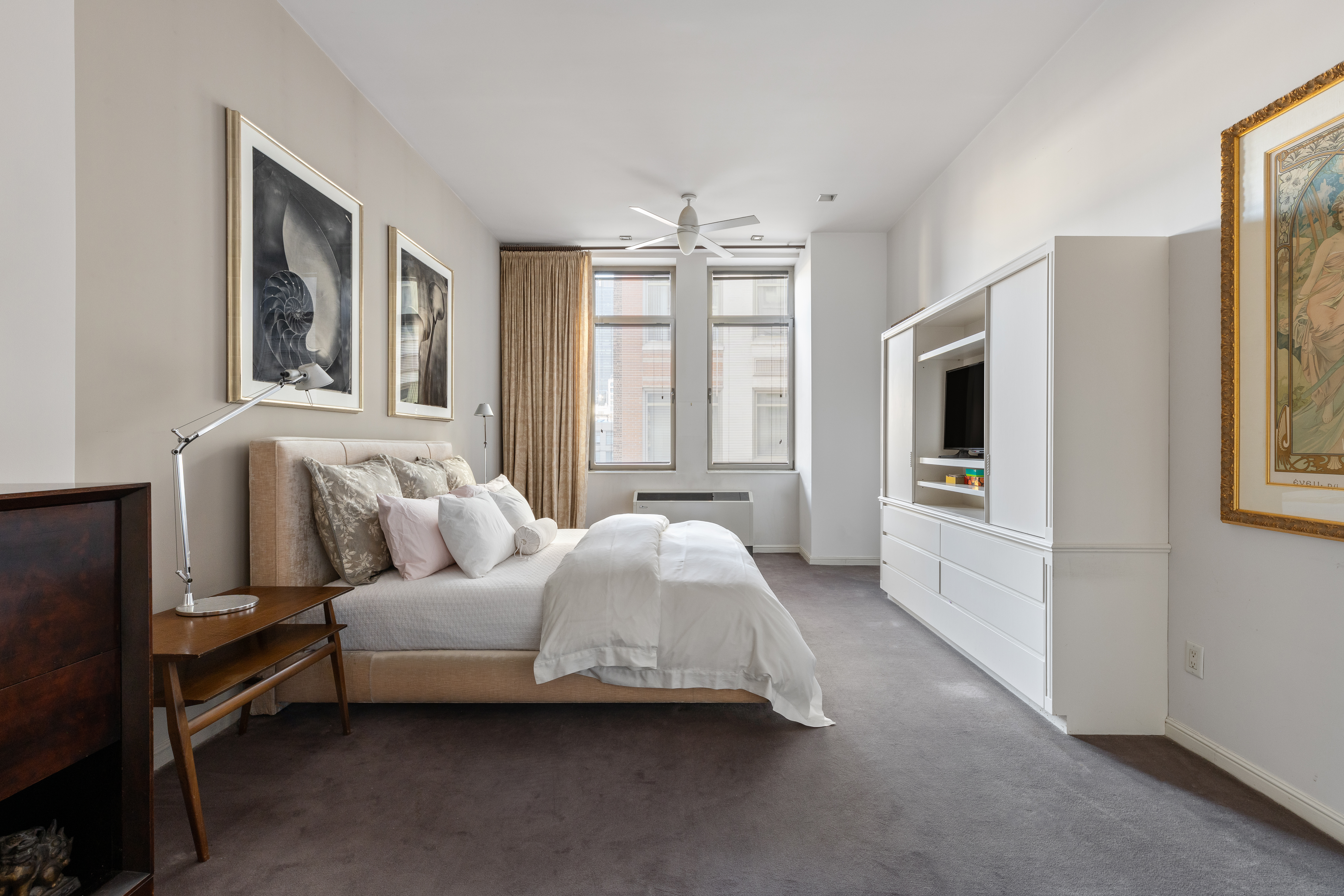 252 7th Avenue, Unit 9X Manhattan, NY 10001 - Photo 10 of 26 a spacious bedroom with a bed couch and a window