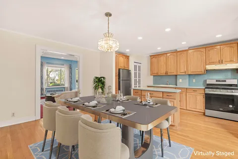 a kitchen with a dining table chairs and stove