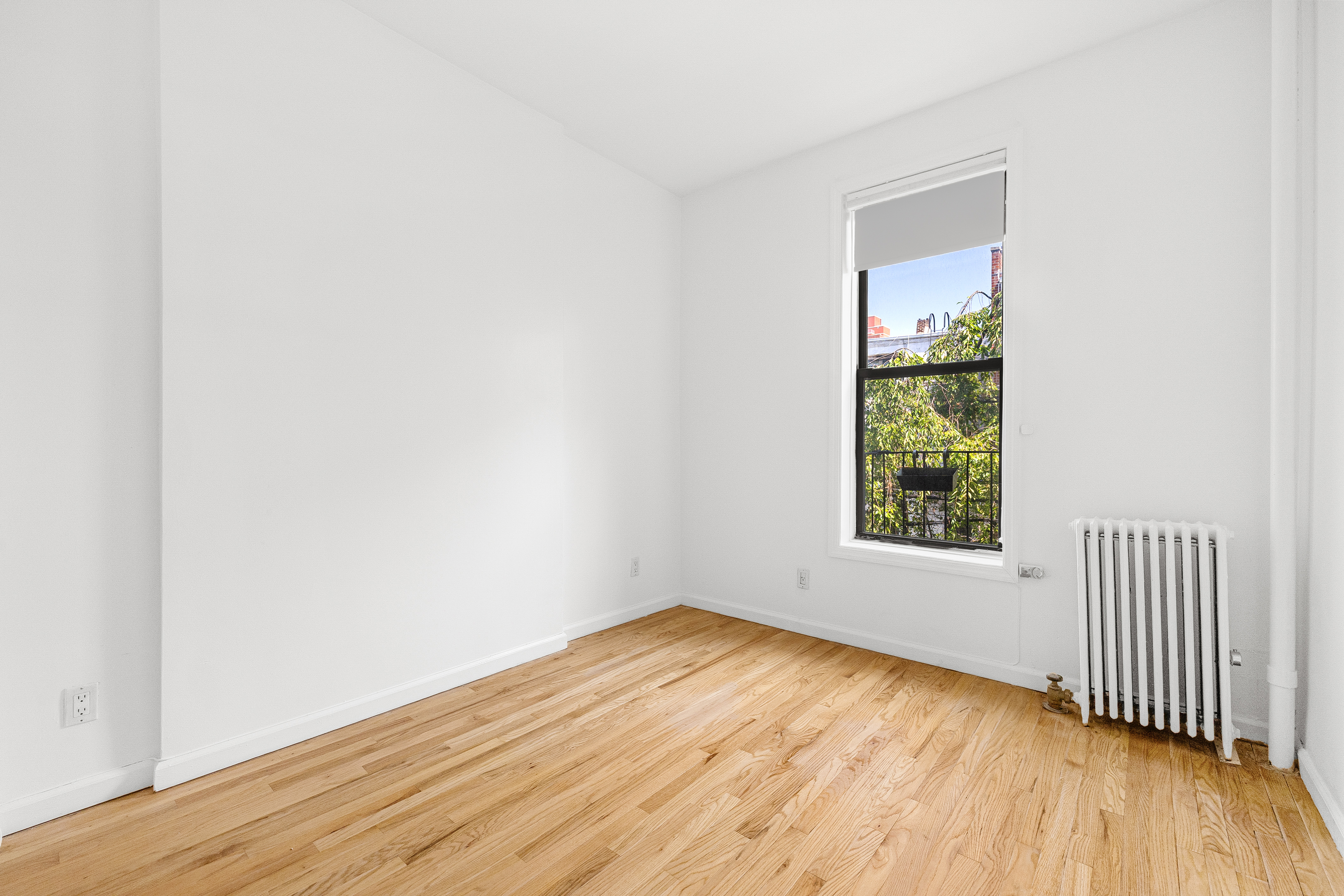 325 3rd Street, Unit 2A Brooklyn, NY 11215 - Photo 2 of 13 an empty room with wooden floor and windows