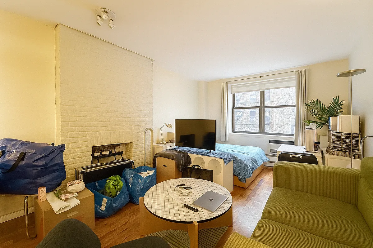 229 East 29th Street, Unit 3A Manhattan, NY 10016 - Photo 2 of 7 a living room with furniture a fireplace and a flat screen tv