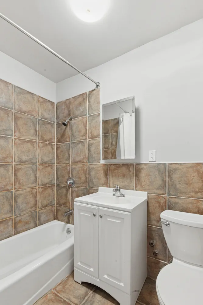 a bathroom with a sink a toilet and bathtub