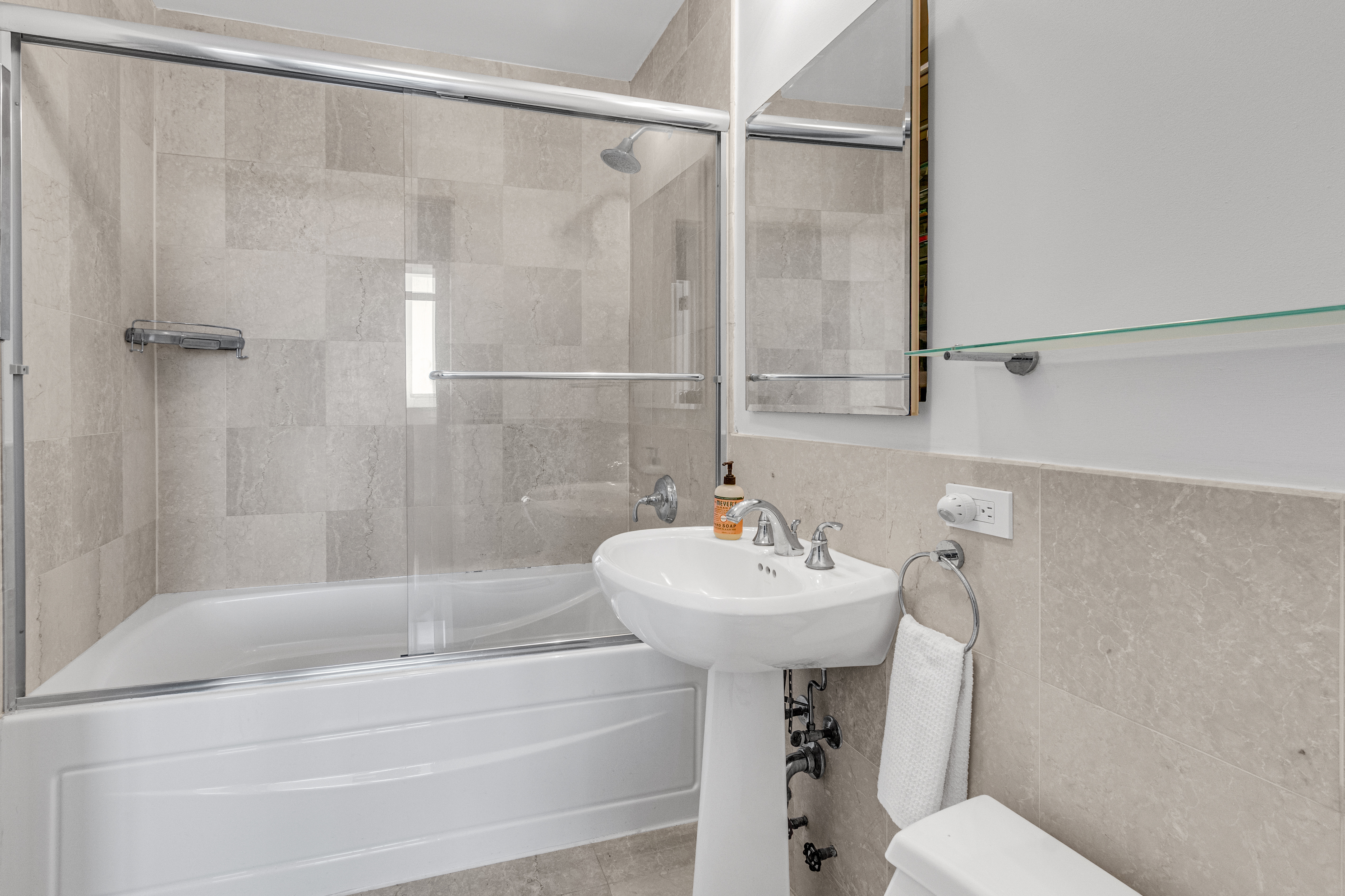 1485 5th Avenue, Unit 24F Manhattan, NY 10035 - Photo 9 of 16 a bathroom with a sink mirror and toilet