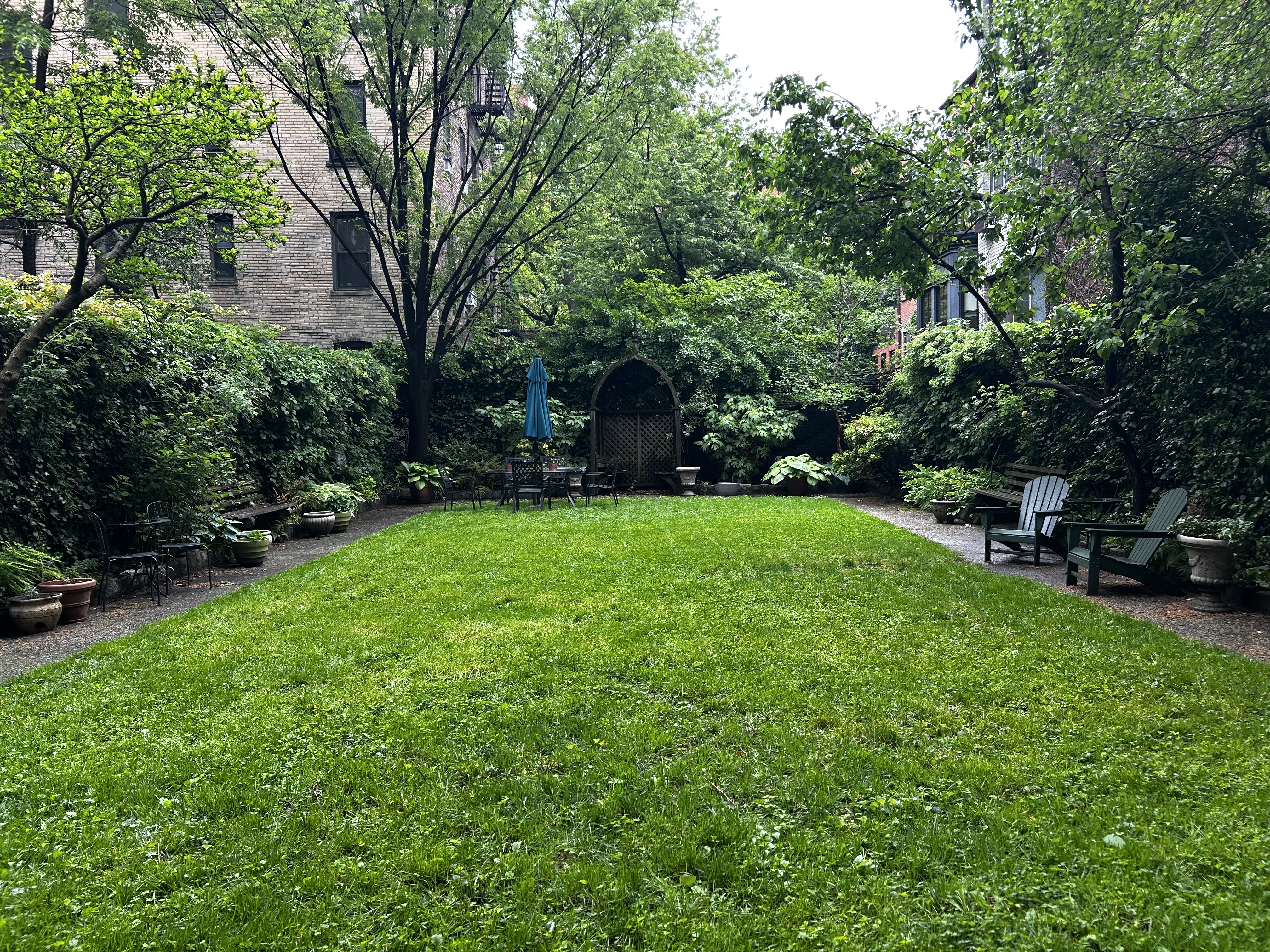 360 West 21st Street, Unit 2L Manhattan, NY 10011 - Photo 8 of 11 a view of a garden with a bench