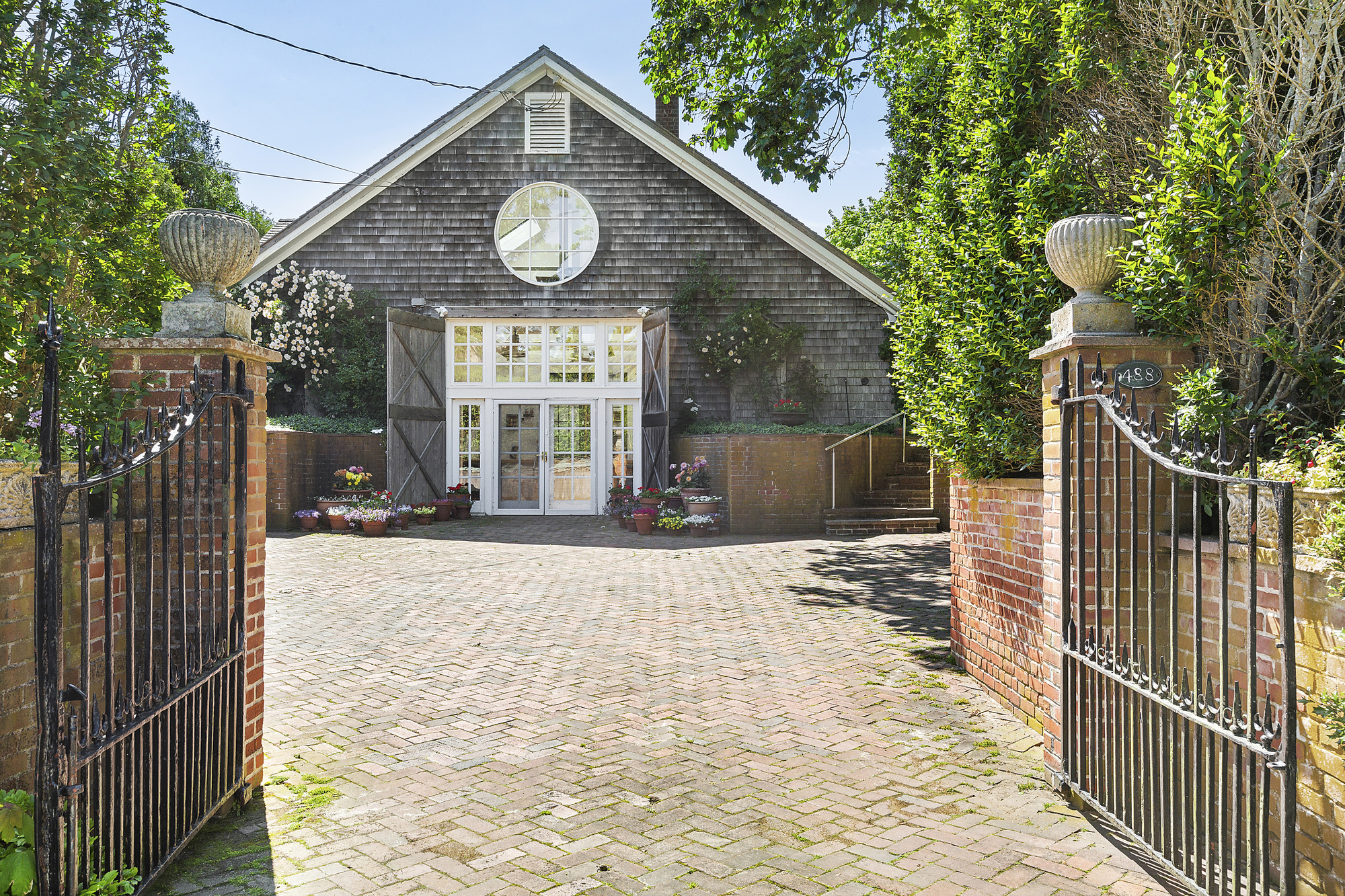 488 Ocean Road Bridgehampton, NY 11932 - Photo 3 of 21 a view of a pathway of a house with wooden fence