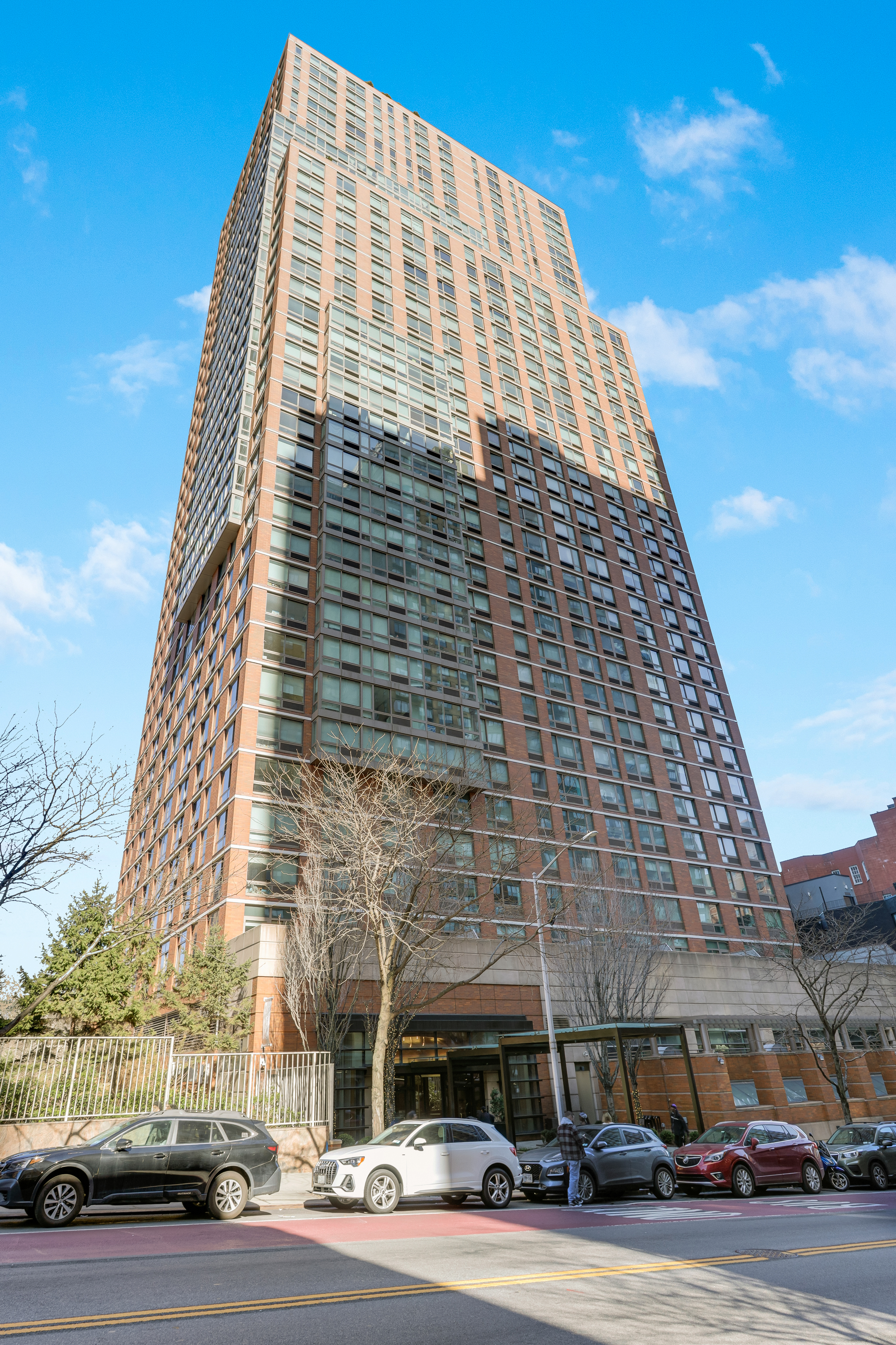 215-217 East 96th Street, Unit 25K Manhattan, NY 10128 - Photo 15 of 16 a tall building sitting on the side of a street