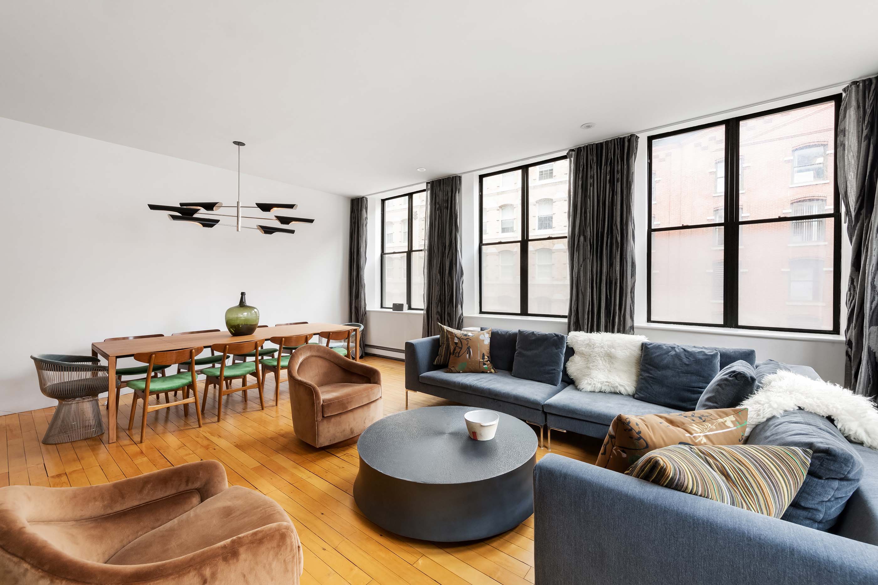 57 Laight Street, Unit 3 Manhattan, NY 10013 - Photo 2 of 15 a living room with furniture and a large window