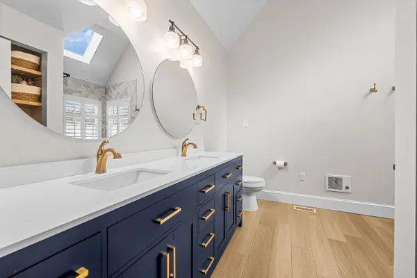 a bathroom with a double vanity sink and a mirror