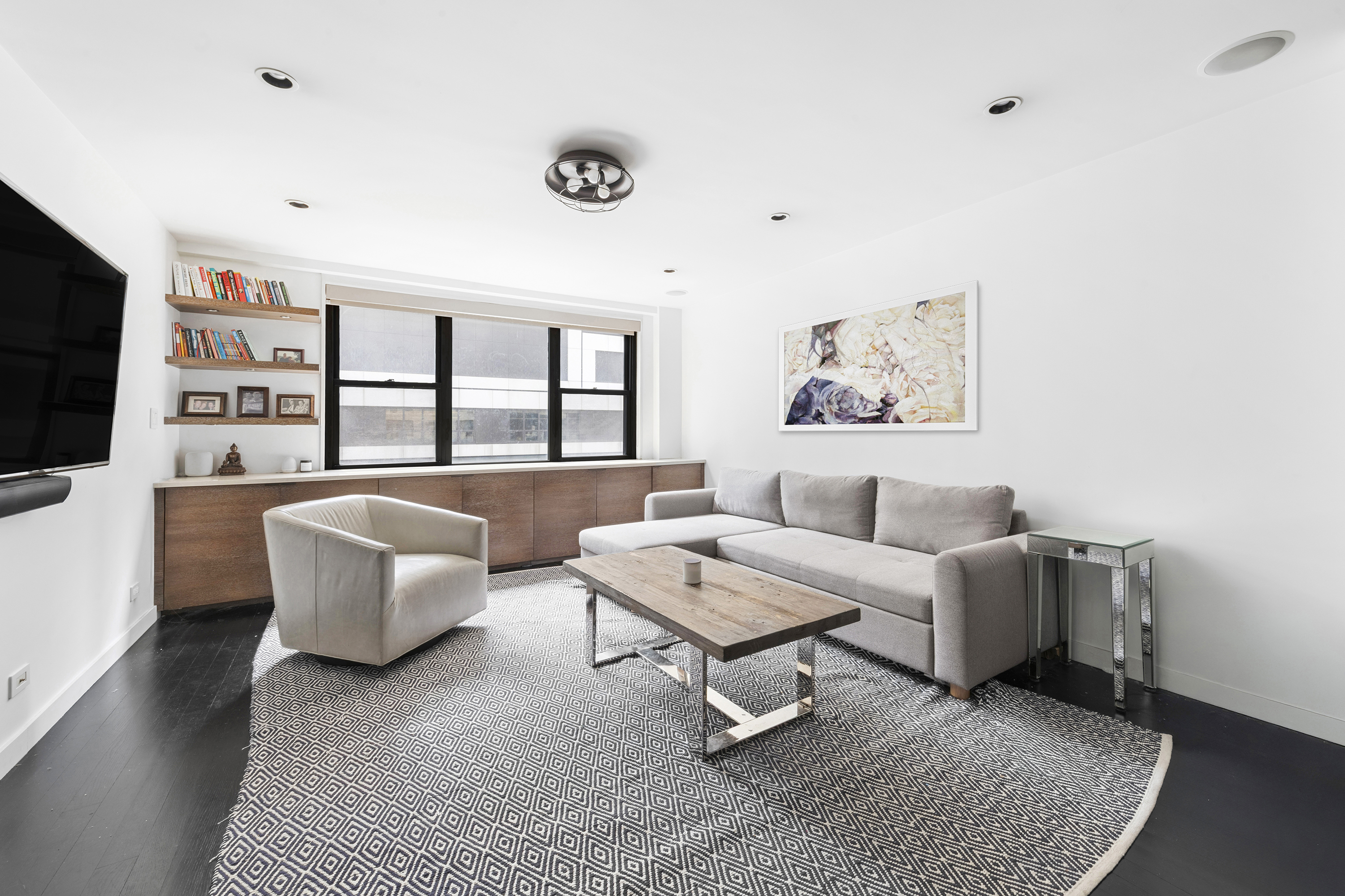 235 East 57th Street, Unit 5D Manhattan, NY 10022 - Photo 2 of 10 a living room with furniture and a flat screen tv