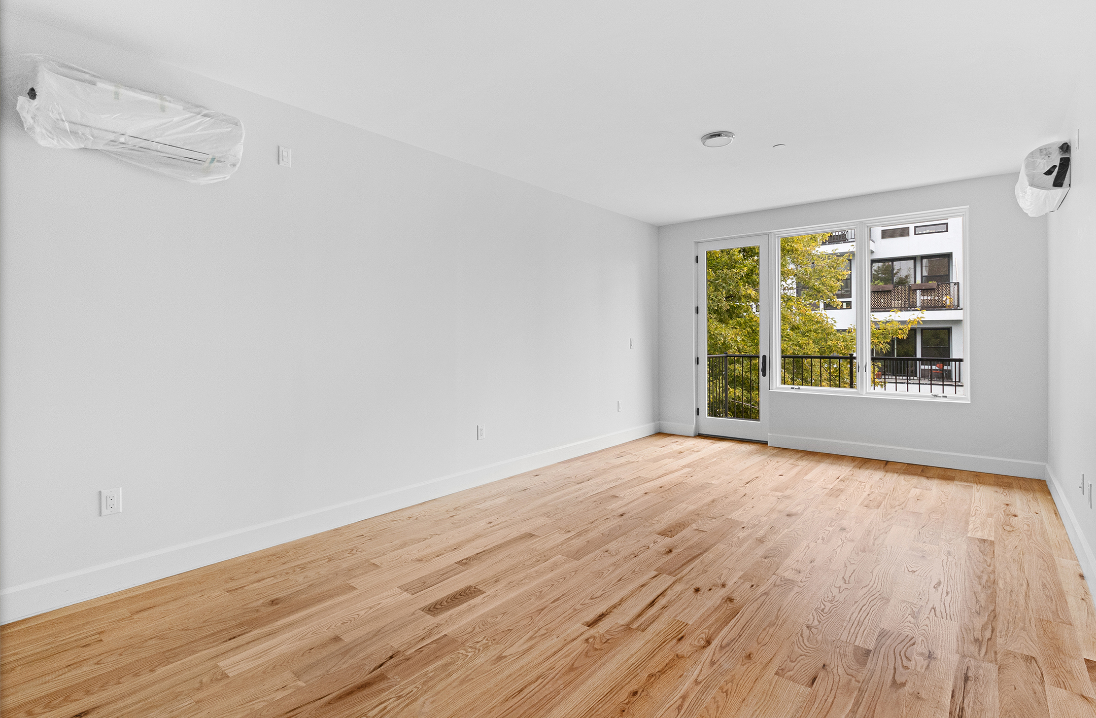1098 Madison Street, Unit 4B Brooklyn, NY 11221 - Photo 2 of 11 a view of an empty room with wooden floor and a window