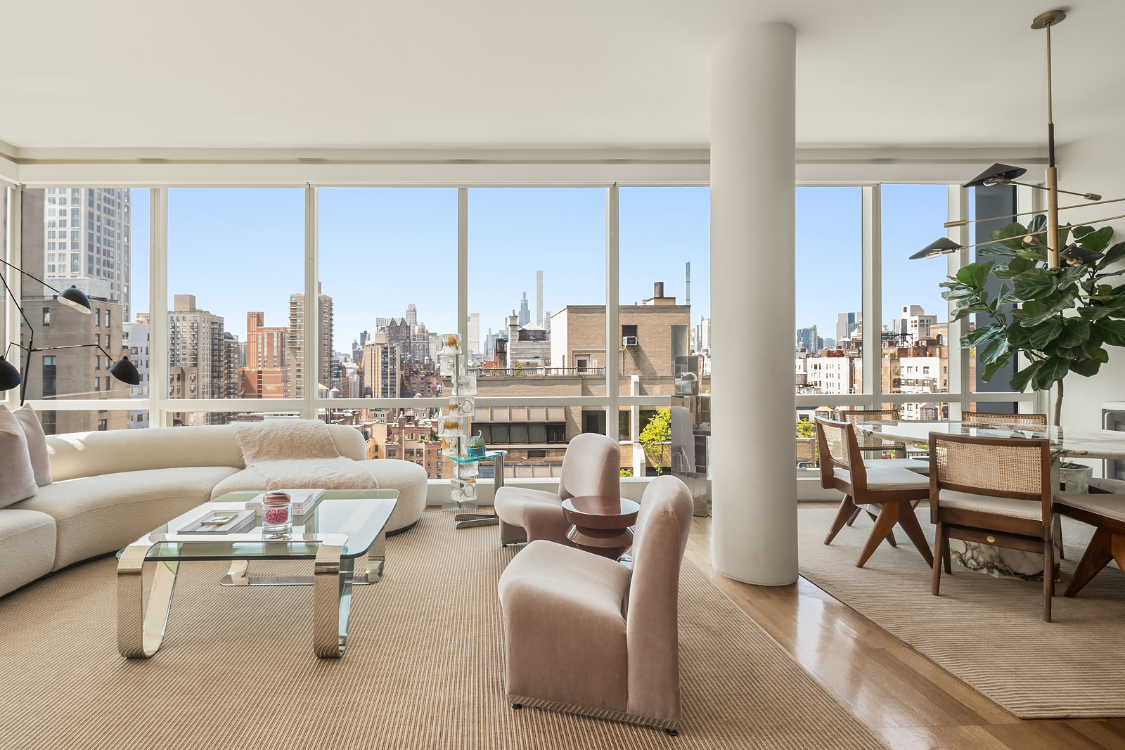151 East 85th Street, Unit 17B Manhattan, NY 10028 - Photo 4 of 10 a living room with furniture and a large window