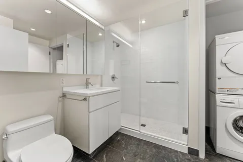 a bathroom with a toilet sink and a shower