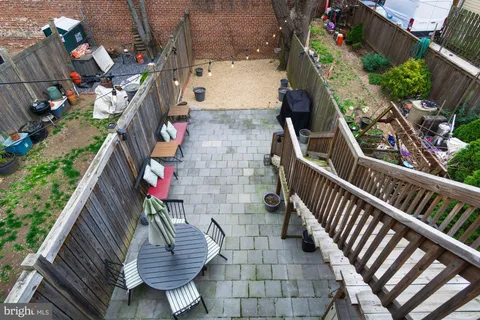 a view of a balcony with a potted plant and wooden floor