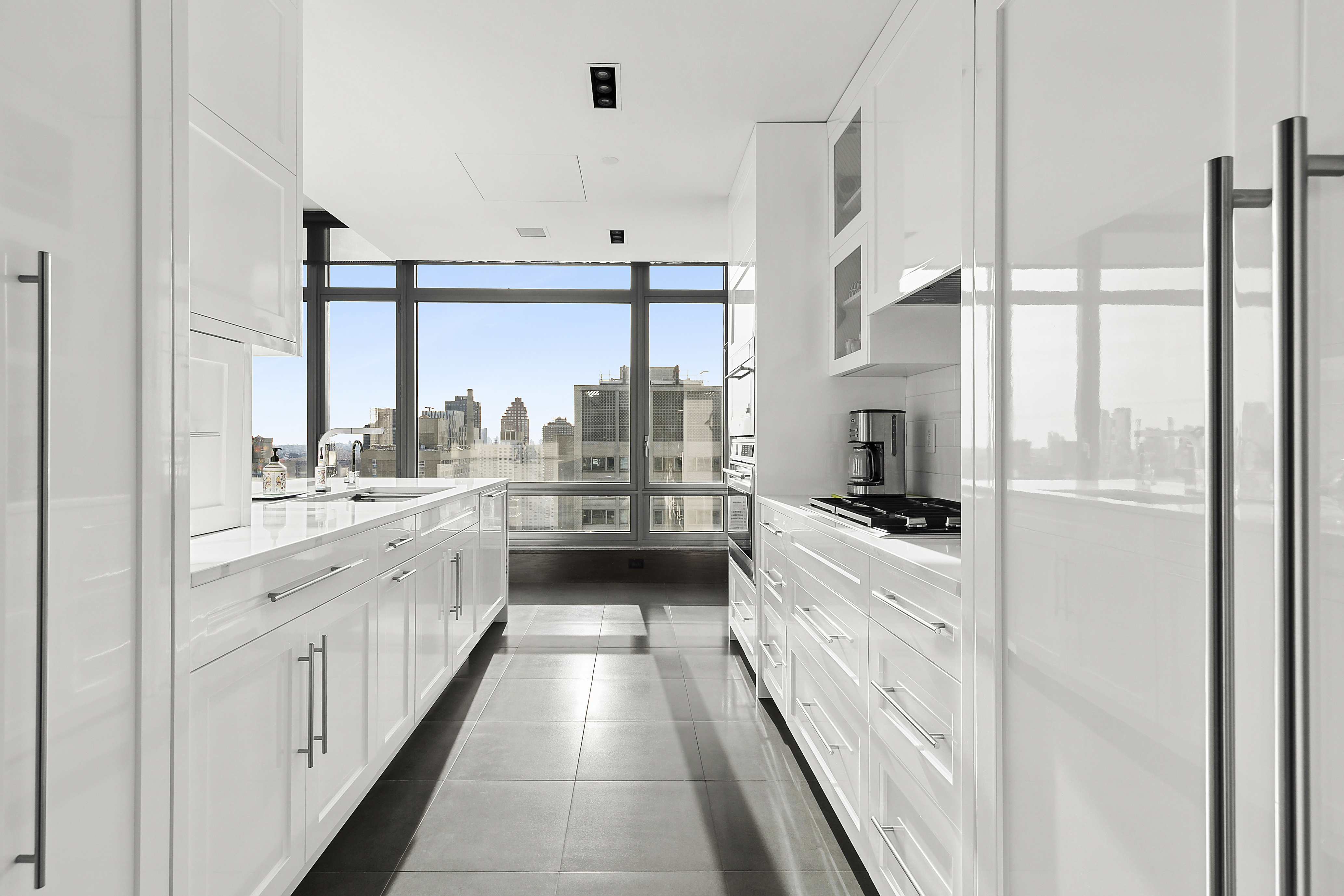 450 East 83rd Street, Unit PH1B Manhattan, NY 10028 - Photo 4 of 15 a large white kitchen with a large window