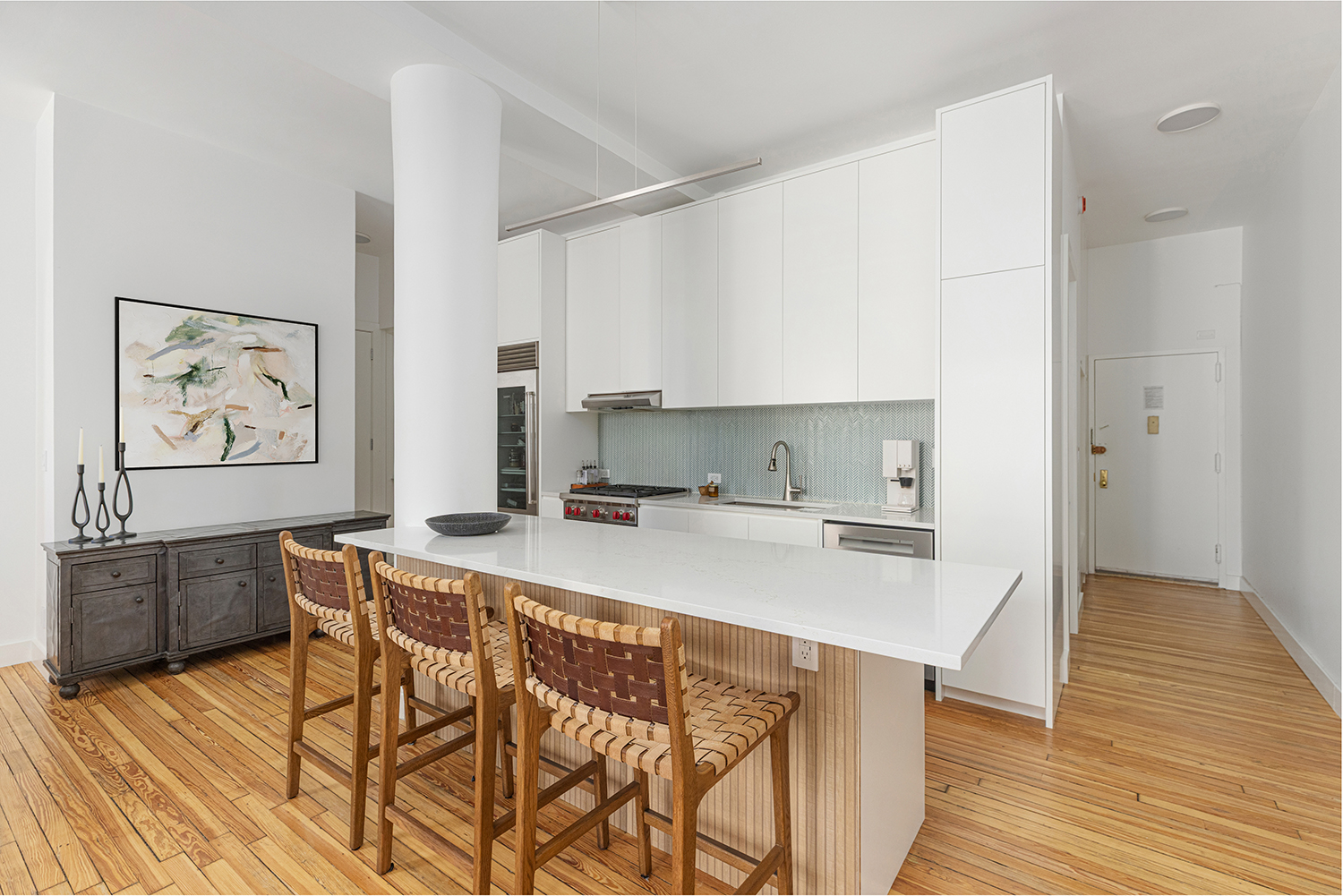 395 Broadway, Unit 5B Manhattan, NY 10013 - Photo 3 of 13 a kitchen with stainless steel appliances a stove a sink dishwasher and cabinets with wooden floor