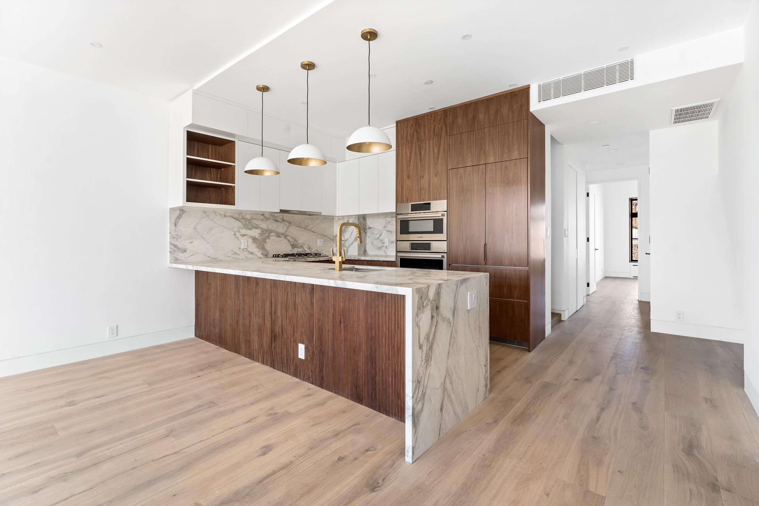 167 13th Street, Unit PH Brooklyn, NY 11215 - Photo 4 of 14 a kitchen with stainless steel appliances kitchen island a refrigerator sink and wooden floor