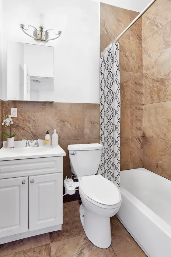 a bathroom with a toilet a sink and bathtub